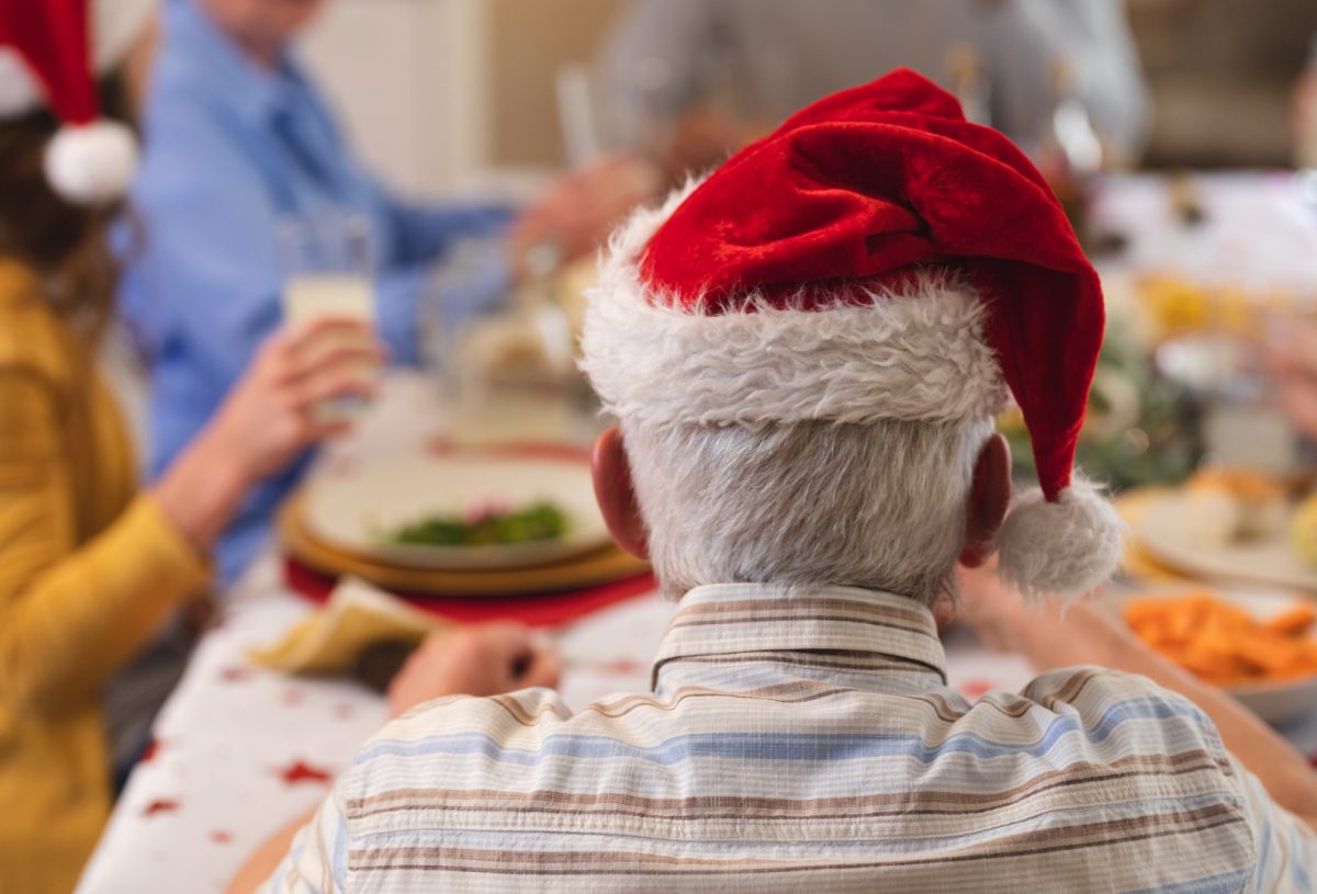 elderly man at dinner table having a Christmas meal 