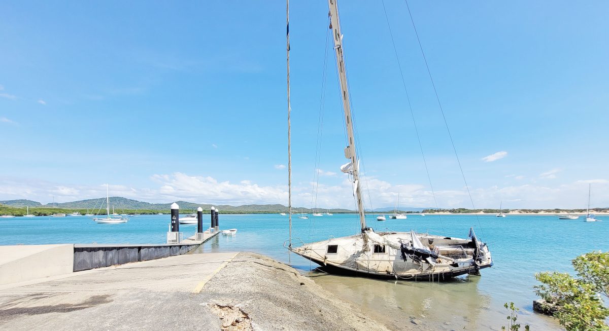 An eyesore on the Cooktown foreshore, the Dancing Dolphin has been left on its side at the public boat ramp for six months.