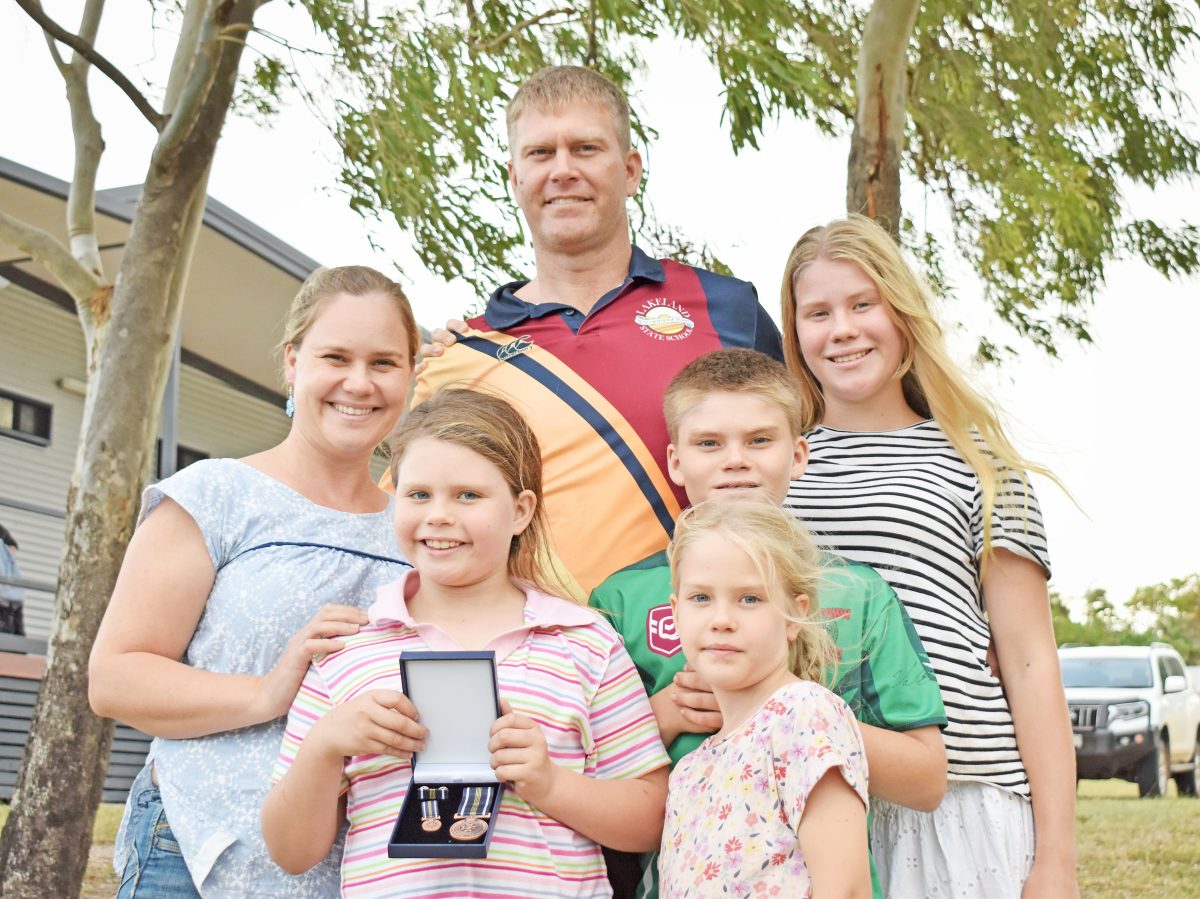 David Kamholtz, with wife Emily and children Esther, Elise, Caleb and Yindili, has been recognised for his service to QFES.