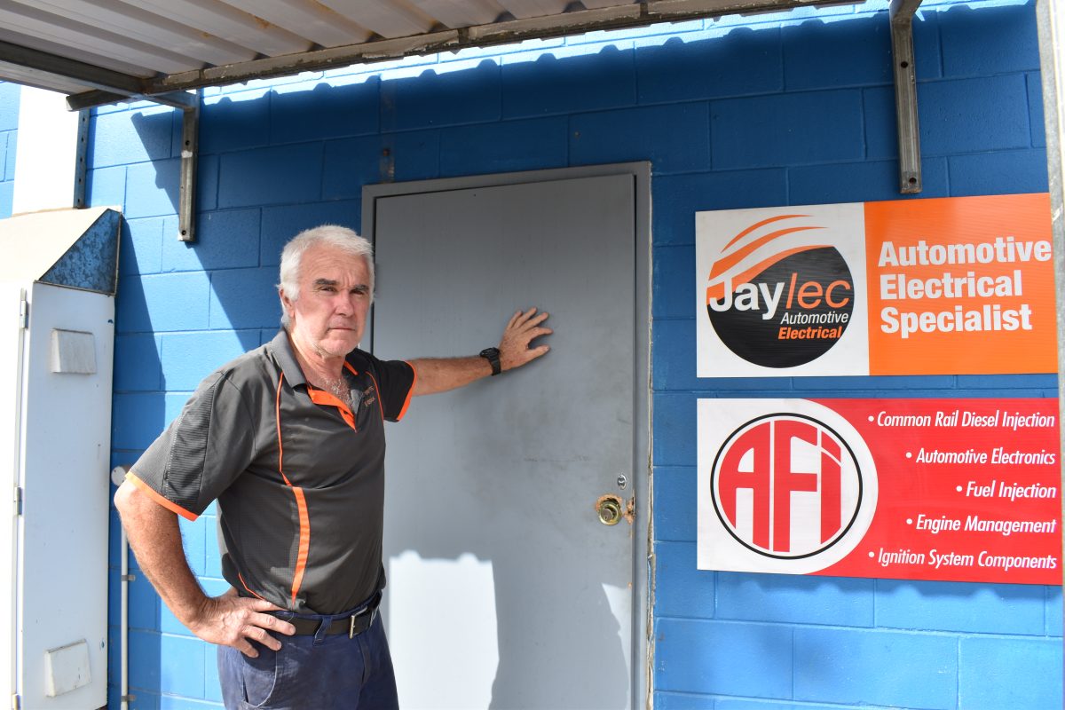 Fred Paterson with the outer security door which was smashed at Cape York Tyres on Saturday.