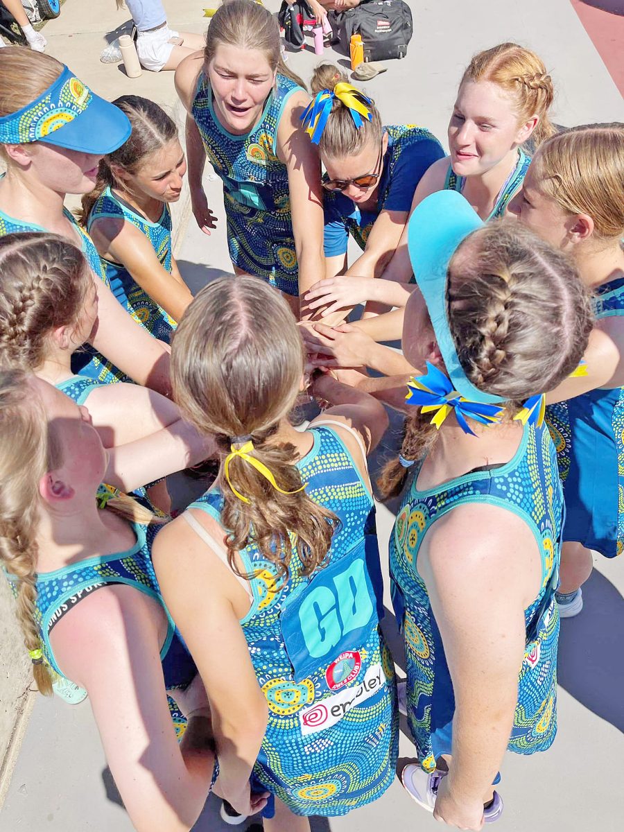 The Weipa 15-years netball side gets fired up for a game in Yeppoon.