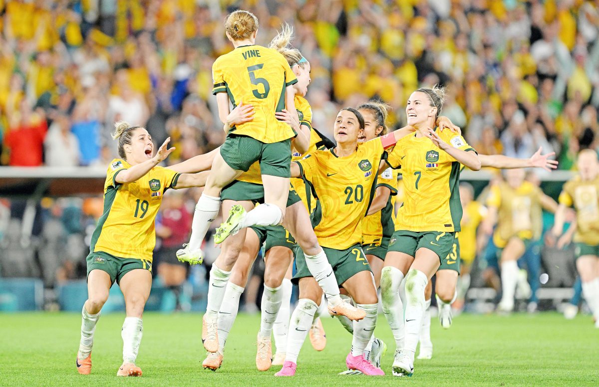 Cortnee Vine of Australia celebrates victory with her team after she scores the winning penalty. Picture: Bradley Kanaris/Getty Images
