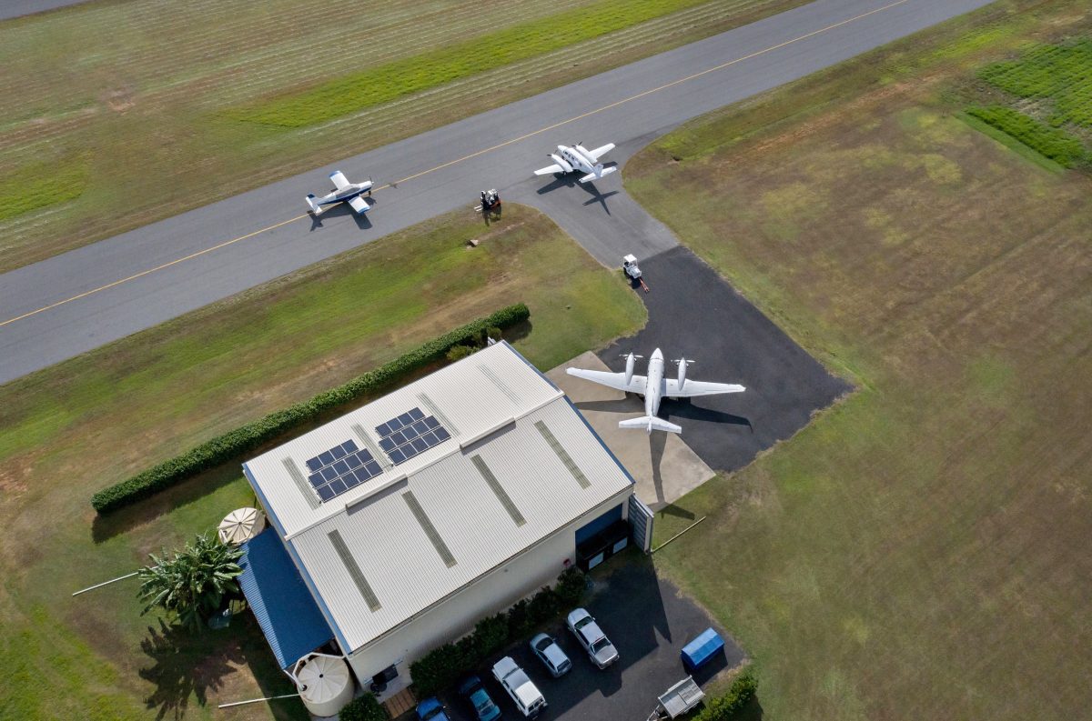 A scenic shot of a remote town runway with 3 Daintree Air aircrafts shown preparing for takeoff.