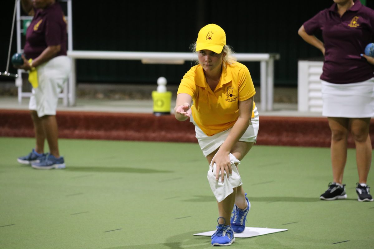 girl competing in lawn bowls