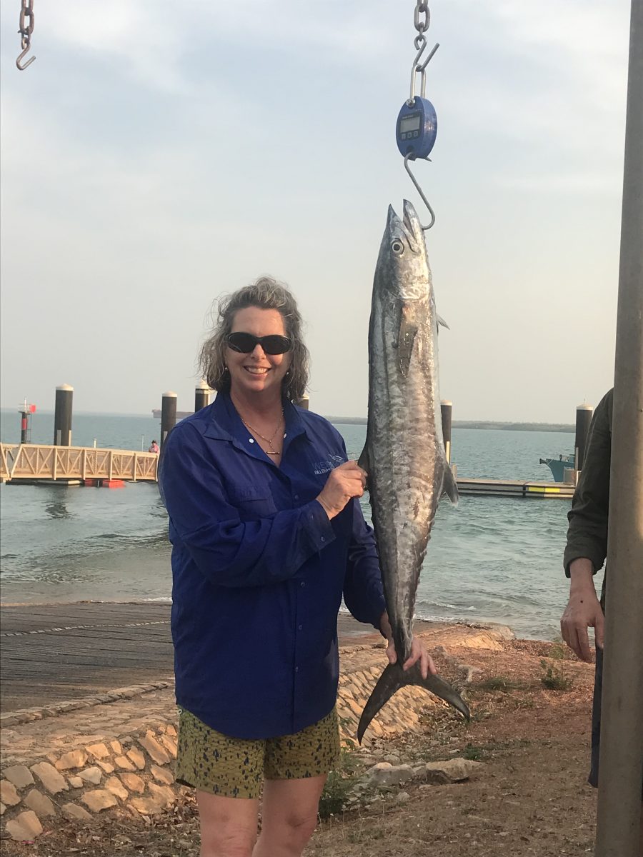 Woman with a mackerel that's supported by a hook
