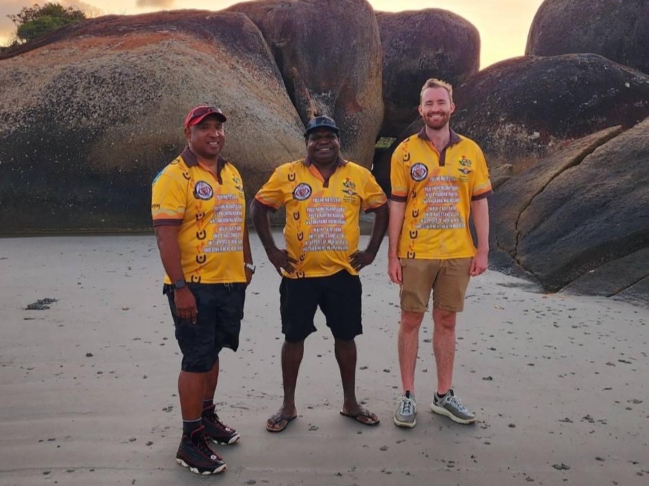 RDFS staff and Lockhart River local on the beach