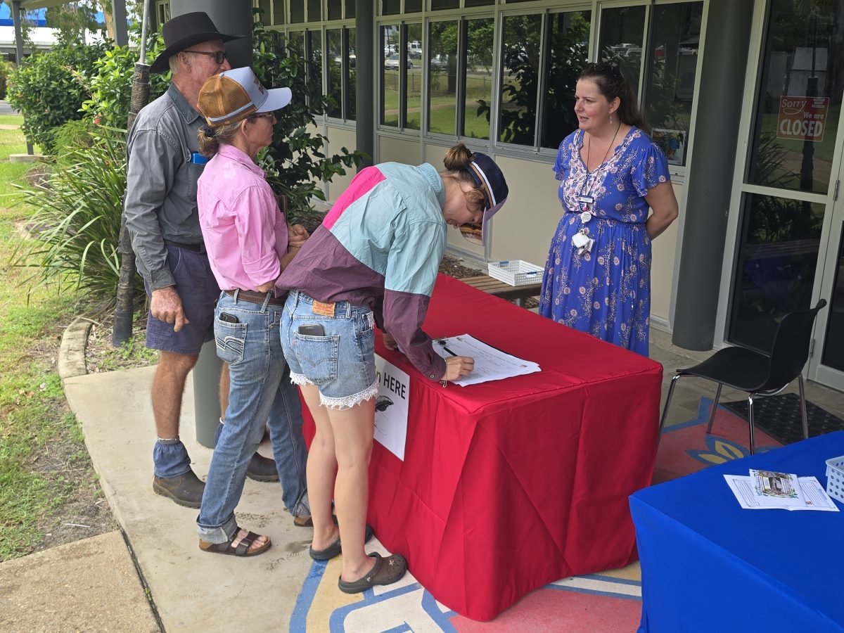 Kirsten Lemon signs in attendees at the Cooktown State School 150th-anniversary celebration