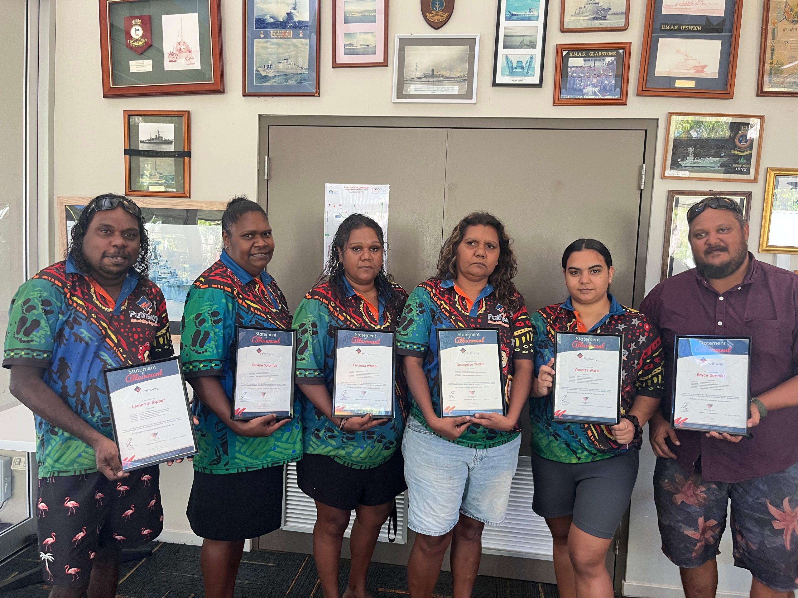 Support workers celebrating their new qualification at graduation ceremony