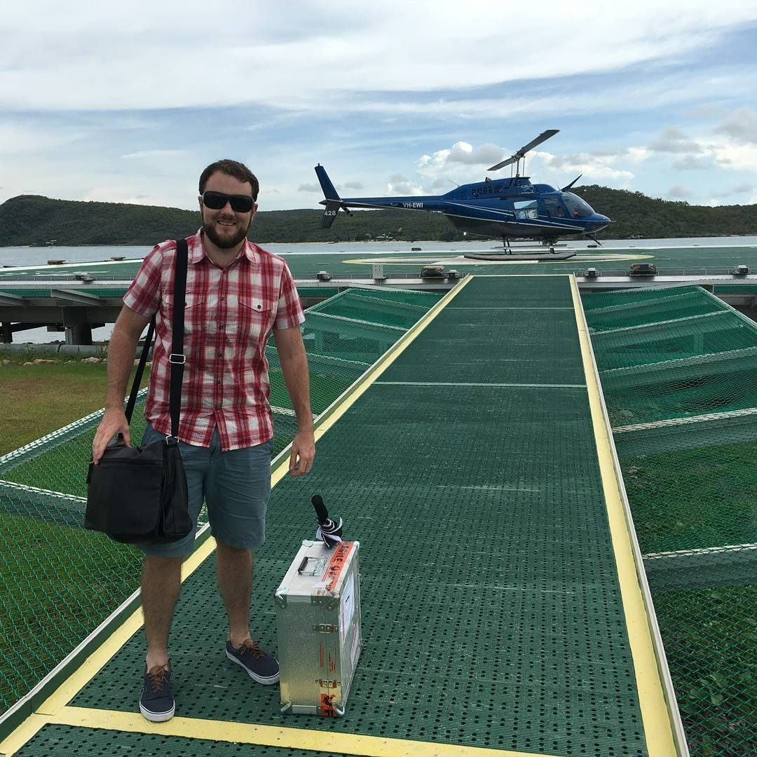 Dr Andrew Scott with bags near a helicopter.