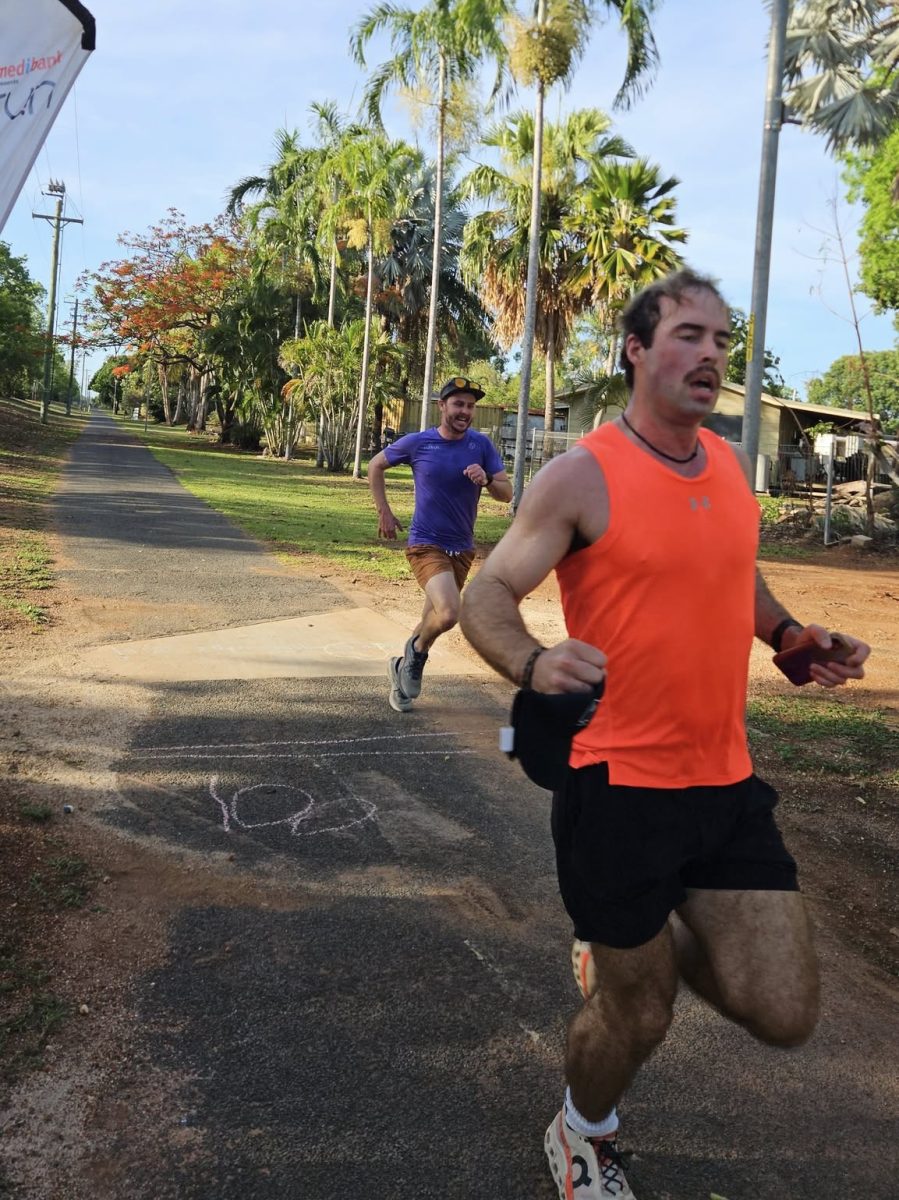 Two runners cross the finish line.
