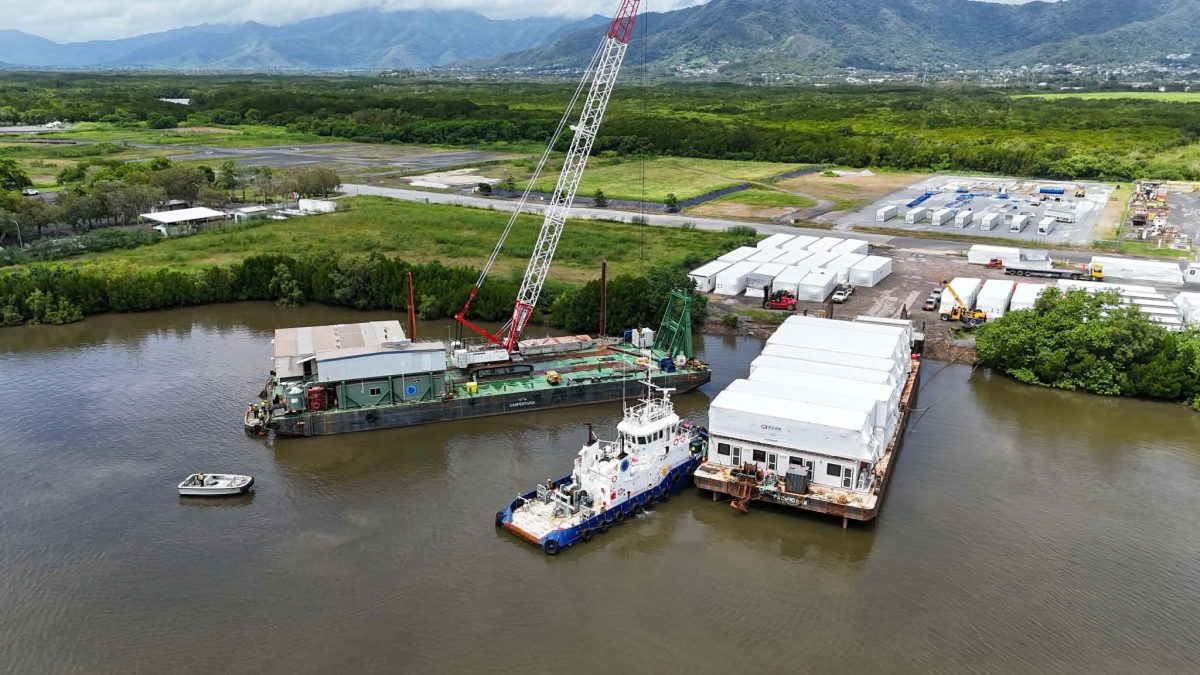 housing modules being transported by a barge